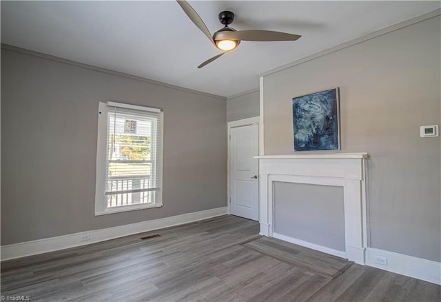 unfurnished living room with ceiling fan, ornamental molding, and hardwood / wood-style flooring