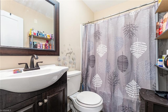 bathroom featuring vanity, toilet, and a shower with shower curtain