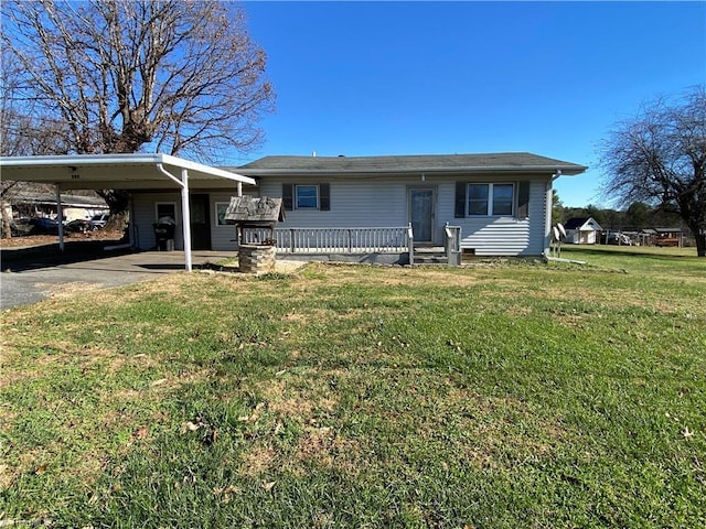 view of front facade featuring covered porch, a front yard, and a carport