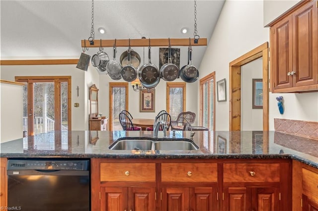 kitchen with a sink, dark stone countertops, brown cabinets, and dishwasher