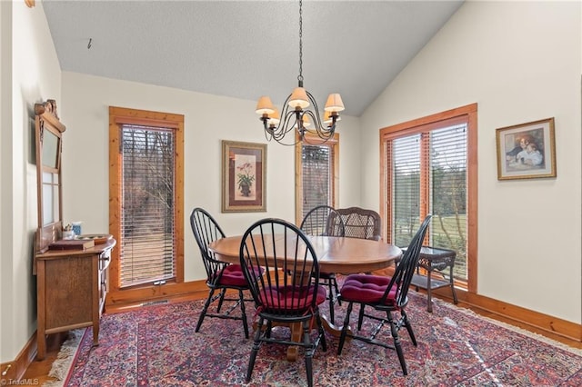 dining room featuring vaulted ceiling, wood finished floors, a chandelier, and baseboards