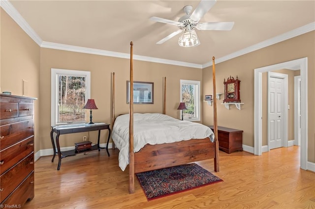 bedroom with light wood-type flooring, baseboards, ornamental molding, and a ceiling fan