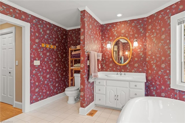 bathroom with tile patterned flooring, toilet, baseboards, a freestanding bath, and wallpapered walls