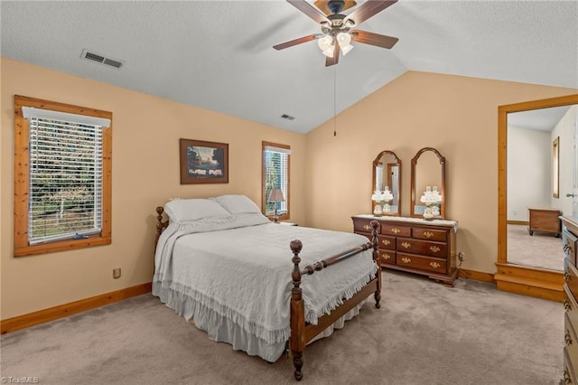 bedroom featuring lofted ceiling, carpet, multiple windows, and visible vents