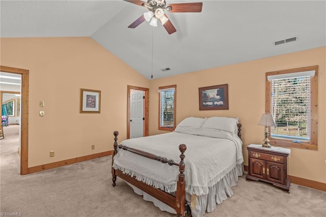 bedroom with light colored carpet, vaulted ceiling, and visible vents