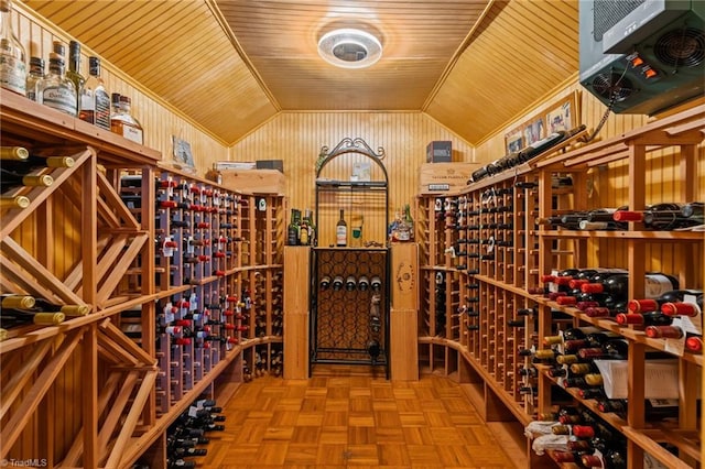 wine room featuring lofted ceiling, wooden ceiling, and wooden walls