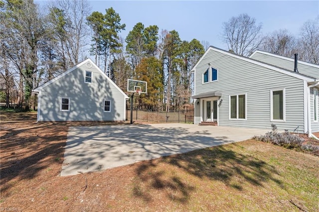 rear view of property with a patio, french doors, a lawn, and fence