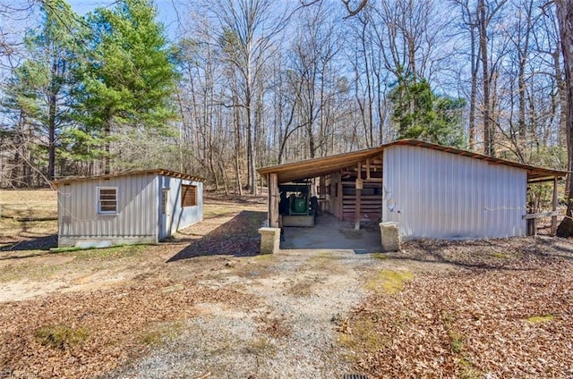 view of pole building featuring a carport and driveway