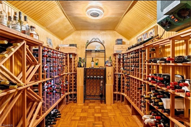 wine cellar with lofted ceiling, wood walls, and wooden ceiling