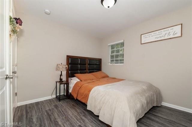 bedroom with dark wood-type flooring