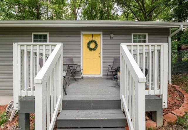 view of exterior entry with a deck