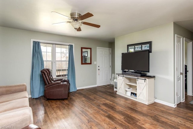 living room featuring ceiling fan and dark hardwood / wood-style flooring