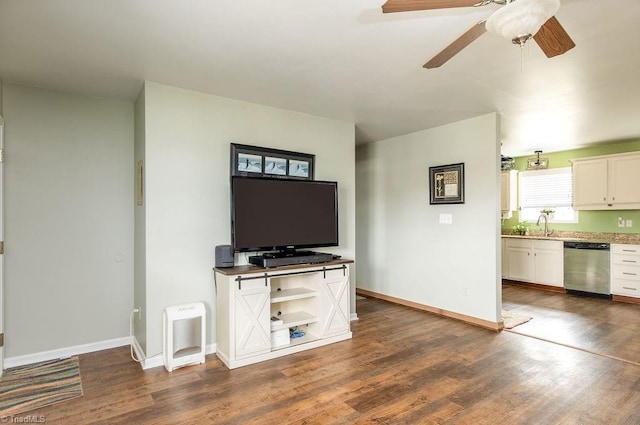 unfurnished living room featuring dark wood-type flooring and ceiling fan