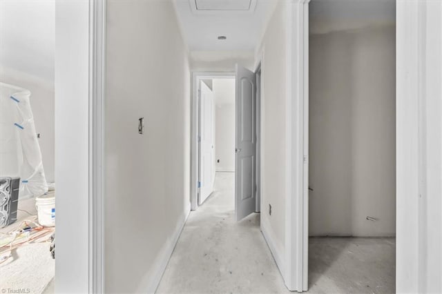 corridor with unfinished concrete flooring