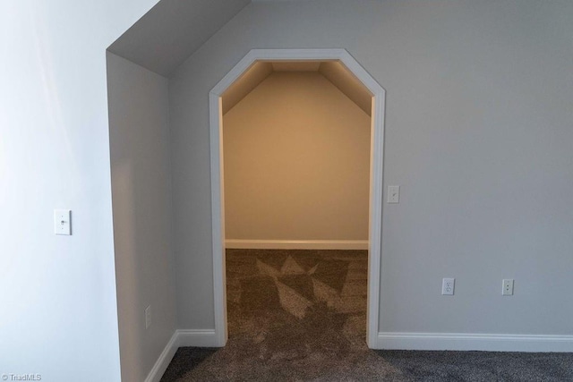 interior space featuring vaulted ceiling and carpet