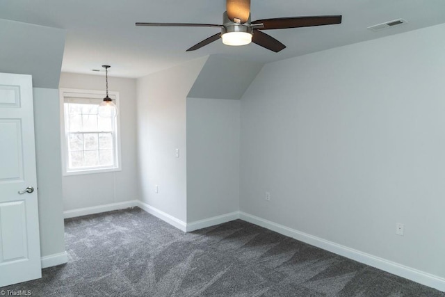 bonus room with ceiling fan, vaulted ceiling, and dark colored carpet