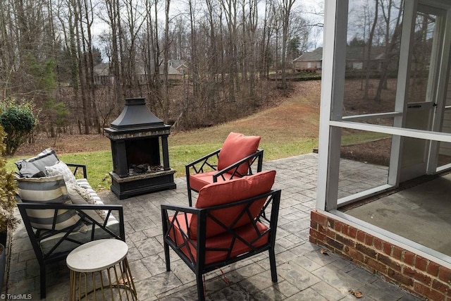 view of patio / terrace featuring an outdoor brick fireplace