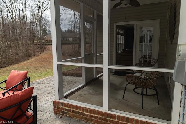 sunroom / solarium featuring ceiling fan