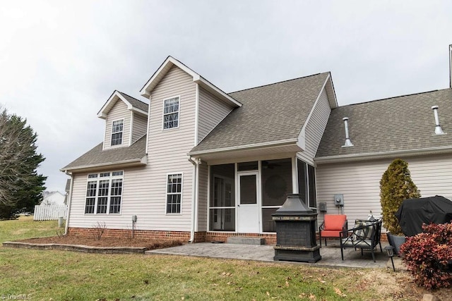 rear view of property with a patio area, a sunroom, and a lawn