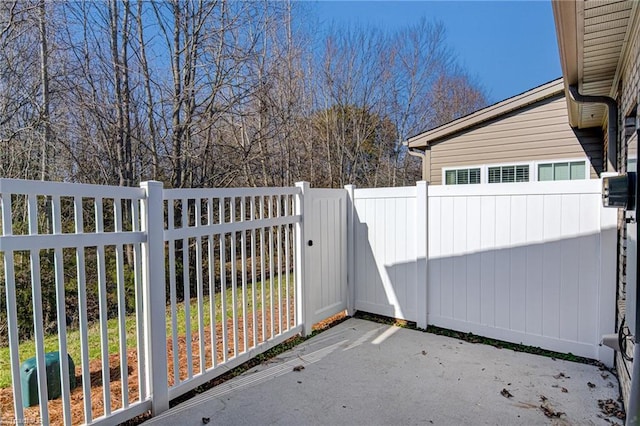 view of gate featuring a patio area