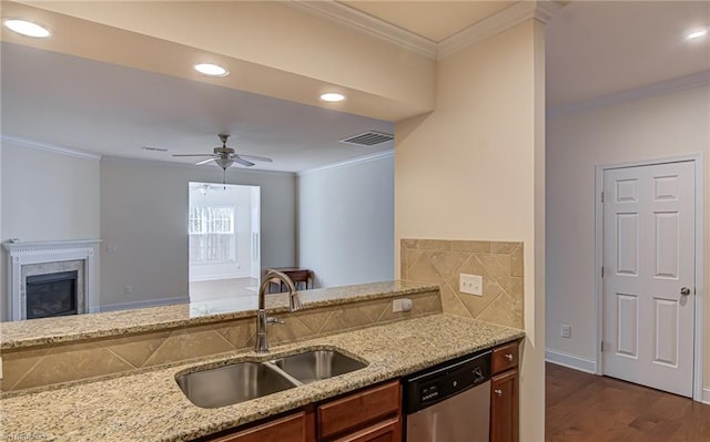 kitchen with light stone counters, stainless steel dishwasher, ceiling fan, crown molding, and sink