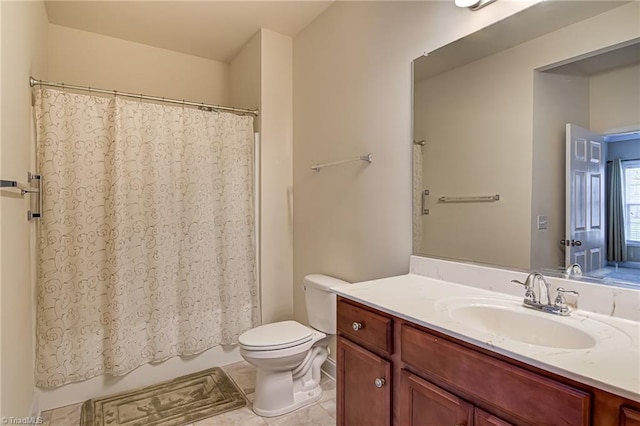 bathroom with tile patterned flooring, vanity, and toilet