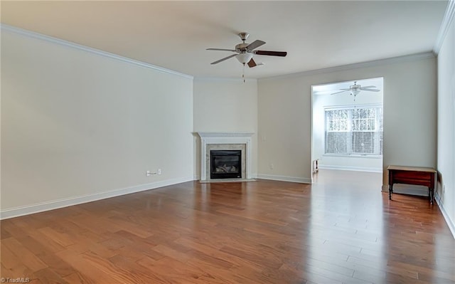 unfurnished living room with hardwood / wood-style flooring, ceiling fan, and crown molding