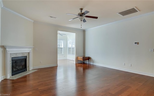 unfurnished living room featuring dark hardwood / wood-style flooring, crown molding, and a tiled fireplace