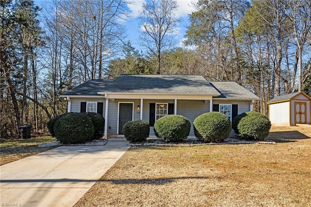 view of front facade with a front yard and a storage shed