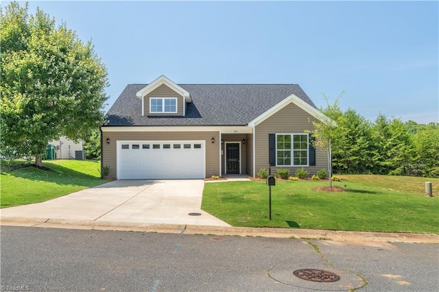 view of front of home with a garage and a front lawn