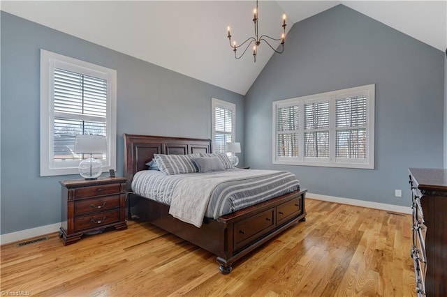 bedroom with a chandelier, high vaulted ceiling, light wood-style flooring, and baseboards