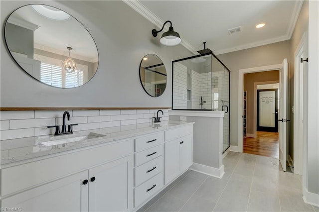 bathroom with ornamental molding, a shower stall, tile patterned flooring, double vanity, and a chandelier