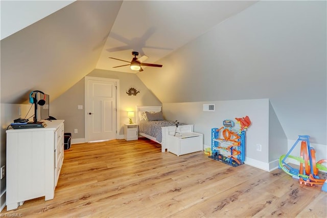 bedroom with light wood-type flooring, lofted ceiling, a ceiling fan, and baseboards