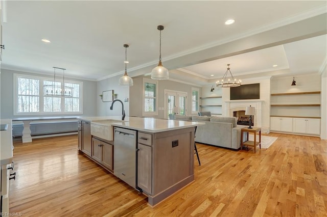 kitchen featuring dishwasher, a sink, plenty of natural light, light wood-style floors, and recessed lighting