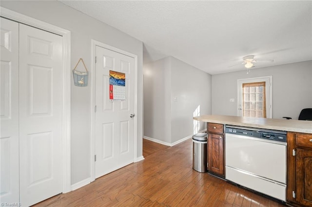 kitchen with ceiling fan, white dishwasher, and light hardwood / wood-style floors