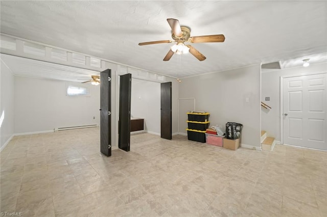 basement featuring ceiling fan and baseboard heating