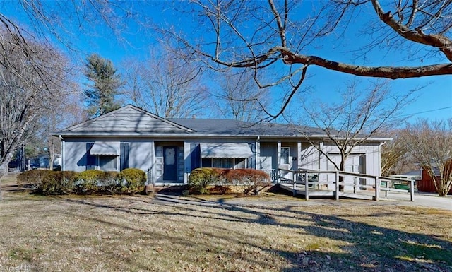 view of front of home featuring a front yard and a deck