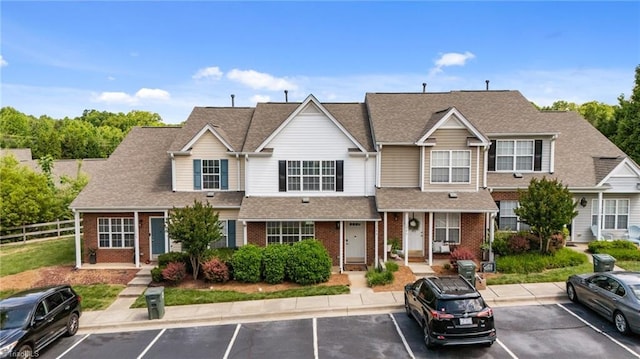 1948 Ray Alexander Dr, Greensboro, NC 27410 - multi unit property with uncovered parking, brick siding, fence, and a shingled roof