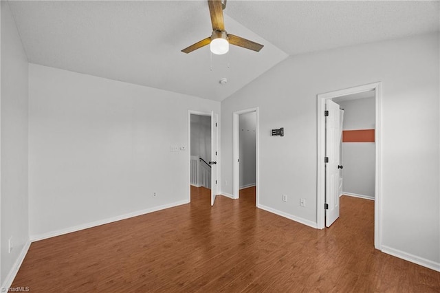 1948 Ray Alexander Dr, Greensboro, NC 27410 - unfurnished bedroom with a spacious closet, lofted ceiling, wood finished floors, a closet, and baseboards