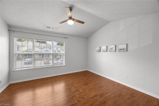 1948 Ray Alexander Dr, Greensboro, NC 27410 - unfurnished room with wood finished floors, vaulted ceiling, a ceiling fan, a textured ceiling, and baseboards