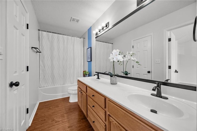 1948 Ray Alexander Dr, Greensboro, NC 27410 - full bath featuring wood finished floors, double vanity, toilet, and shower / tub combo with curtain