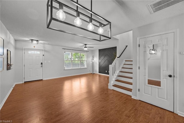 1948 Ray Alexander Dr, Greensboro, NC 27410 - foyer featuring stairs, wood finished floors, a ceiling fan, and baseboards