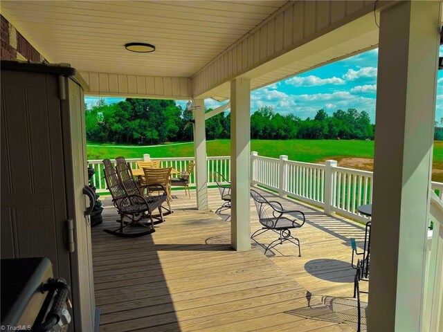 wooden deck featuring a yard