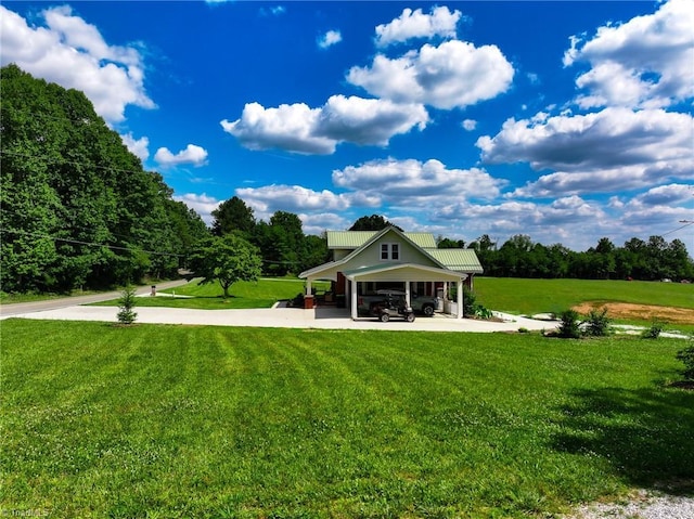 view of property's community featuring an attached carport, driveway, and a yard