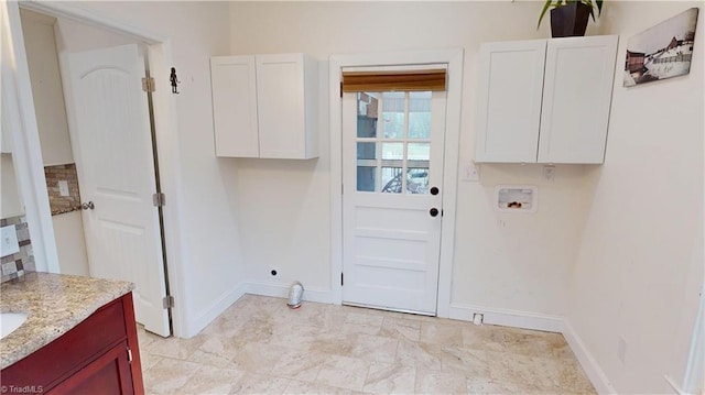 laundry room featuring cabinet space, hookup for an electric dryer, baseboards, and washer hookup