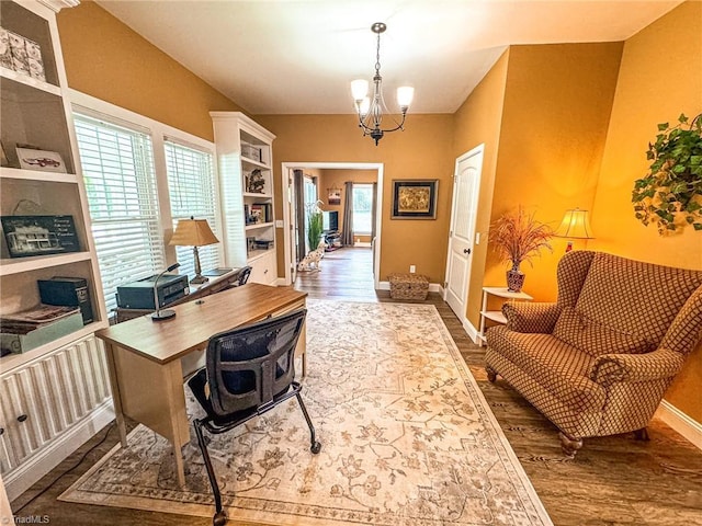 office with baseboards, a notable chandelier, and wood finished floors