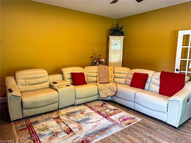 living area featuring wood finished floors and a ceiling fan