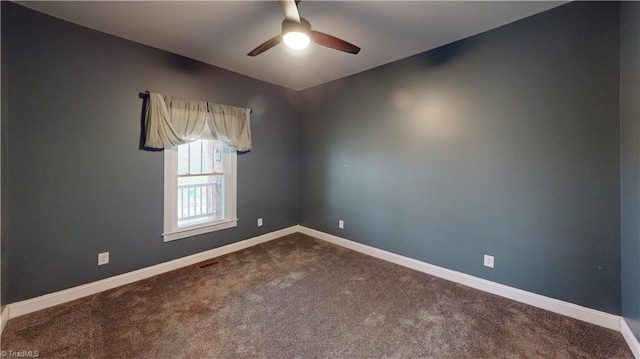 unfurnished room with baseboards, visible vents, ceiling fan, and dark carpet