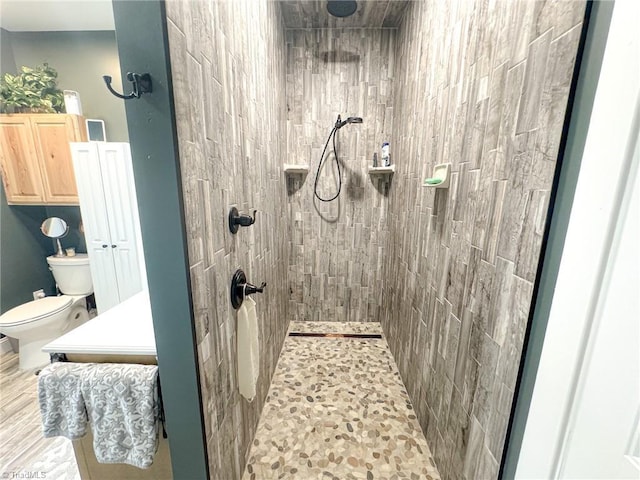 full bathroom with toilet and tiled shower