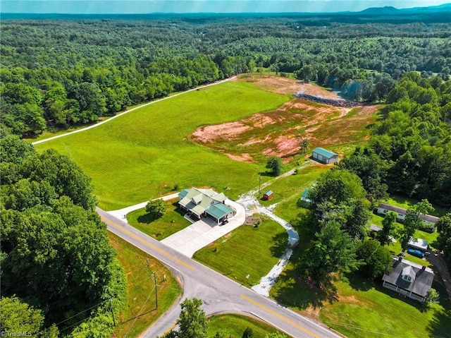 drone / aerial view with a wooded view
